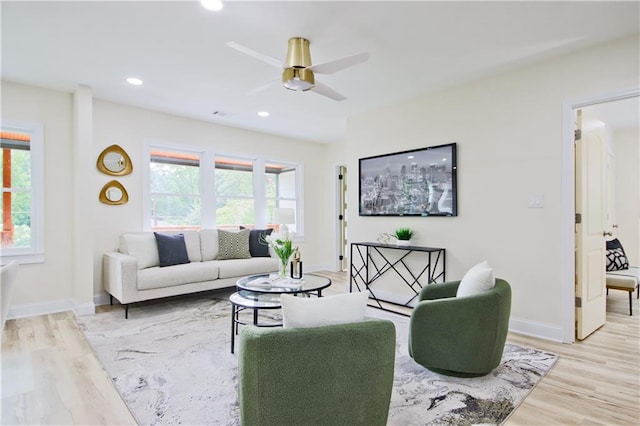 living room featuring ceiling fan and light hardwood / wood-style floors