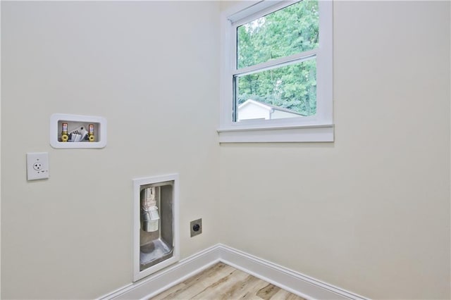 washroom with hookup for an electric dryer, hardwood / wood-style flooring, and washer hookup