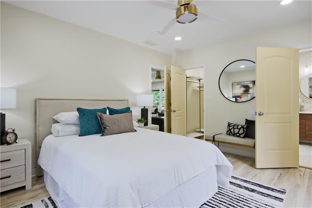 bedroom with a closet, light hardwood / wood-style floors, and ceiling fan