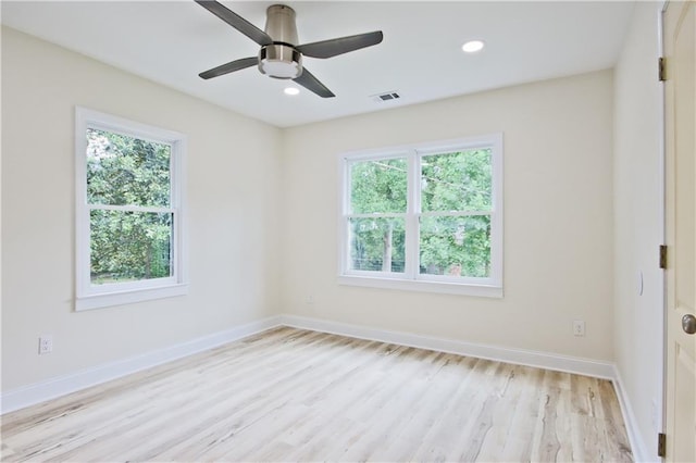 empty room with ceiling fan and light hardwood / wood-style flooring