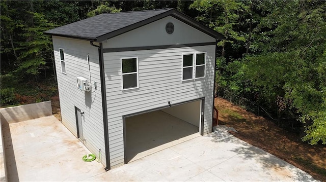 view of front of home with a garage and a patio area