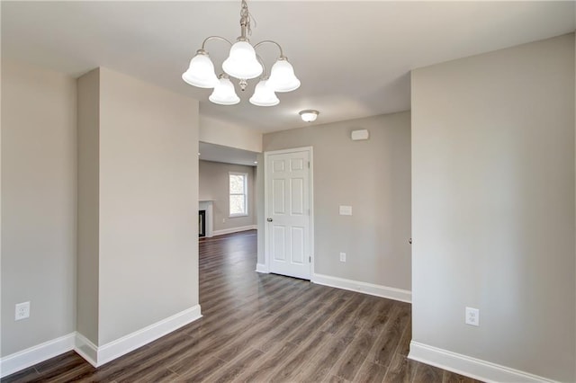 interior space featuring dark wood-type flooring and a chandelier