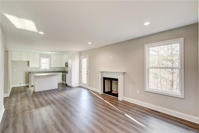 unfurnished living room featuring dark hardwood / wood-style flooring