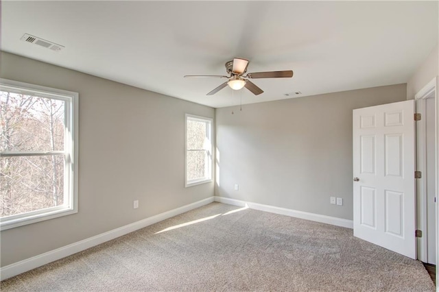 empty room with carpet floors and ceiling fan