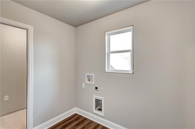 clothes washing area with hookup for a washing machine, light wood-type flooring, and hookup for an electric dryer