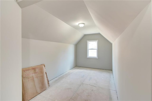 additional living space featuring lofted ceiling