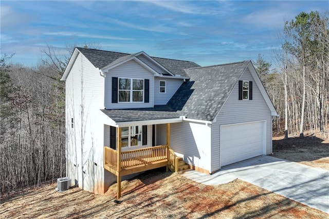 view of front of house featuring central AC unit, a garage, and covered porch