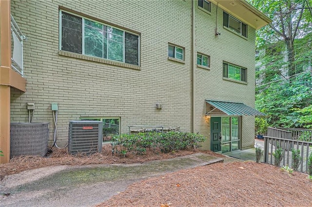 3046 Briarcliff Rd NE Unit 15, Atlanta, GA 30329 - view of side of property with central AC unit and brick siding