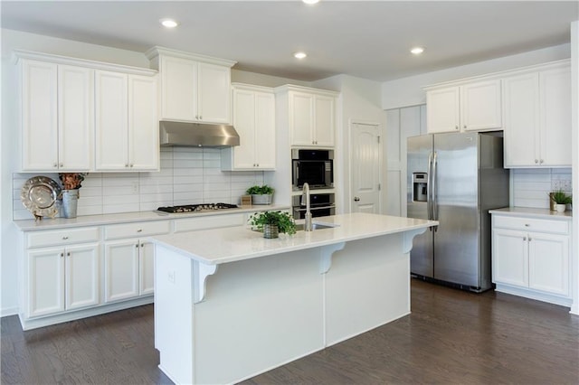 1962 Bainbridge Ln, Chamblee, GA 30345 - kitchen with stainless steel appliances, under cabinet range hood, tasteful backsplash, white cabinets, and recessed lighting