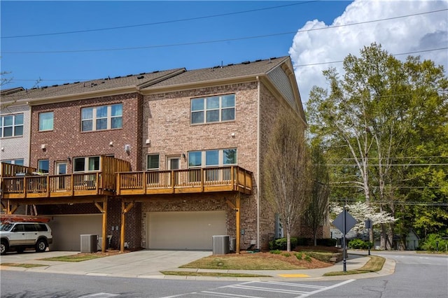 1962 Bainbridge Ln, Chamblee, GA 30345 - back of house featuring brick siding, driveway, and a garage