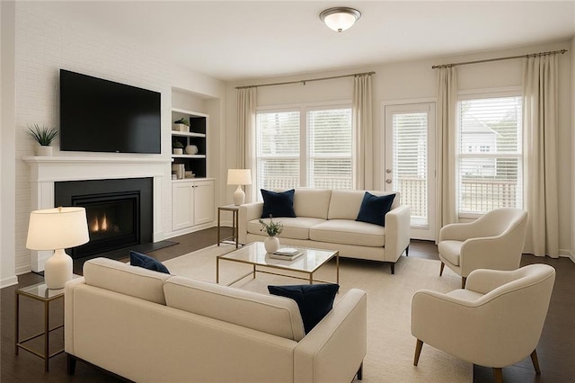 1962 Bainbridge Ln, Chamblee, GA 30345 - living room with built in shelves, a large fireplace, and wood finished floors