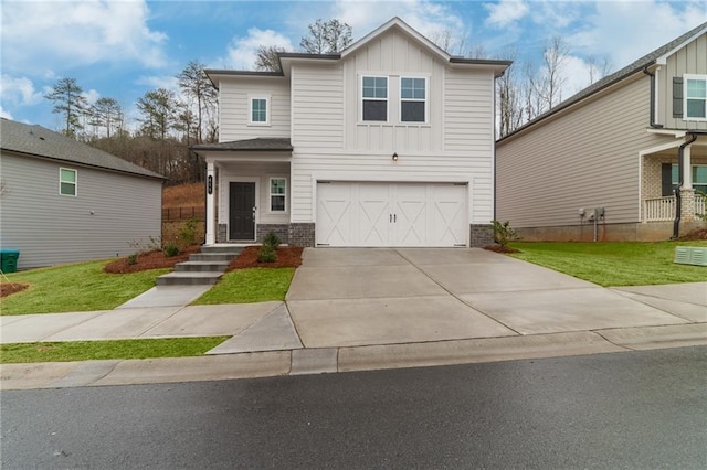 view of front of property with driveway, a front yard, brick siding, board and batten siding, and a garage