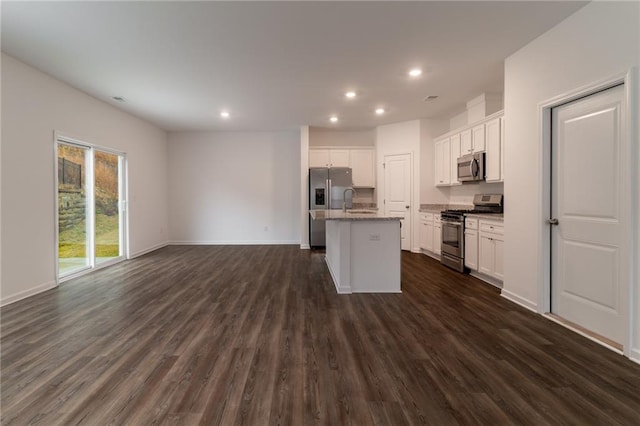 kitchen featuring open floor plan, white cabinets, dark wood-style floors, and appliances with stainless steel finishes