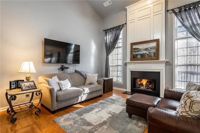 living room featuring light hardwood / wood-style floors and lofted ceiling