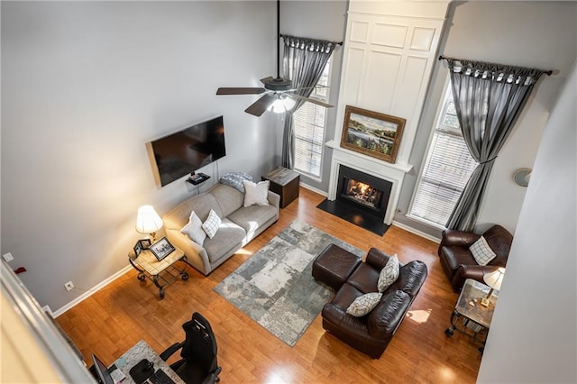 living room featuring ceiling fan and hardwood / wood-style flooring