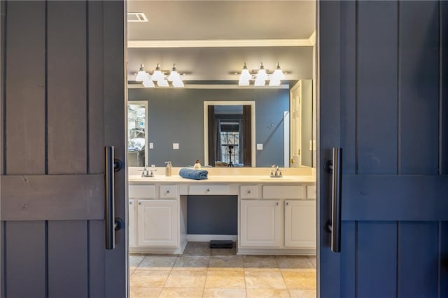 bathroom featuring crown molding, tile patterned flooring, and vanity