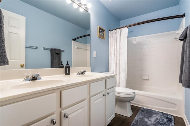 full bathroom with shower / bathtub combination with curtain, hardwood / wood-style floors, vanity, and toilet