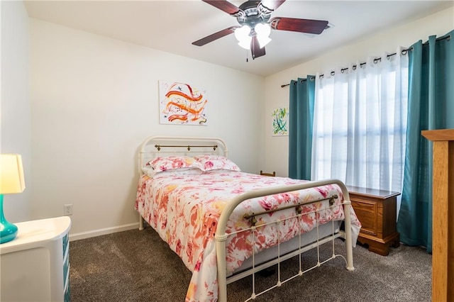 carpeted bedroom with multiple windows and ceiling fan