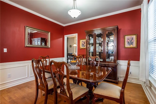 dining room featuring ornamental molding and hardwood / wood-style flooring