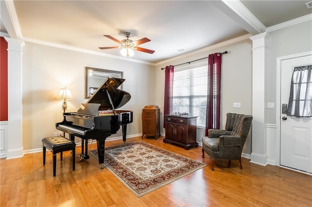 sitting room featuring ornate columns, crown molding, light hardwood / wood-style flooring, and ceiling fan