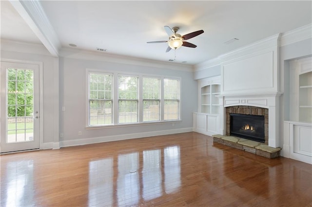 4652 Prater Way SE, Smyrna, GA 30080 - unfurnished living room with crown molding, light wood-style floors, ceiling fan, a fireplace, and built in features