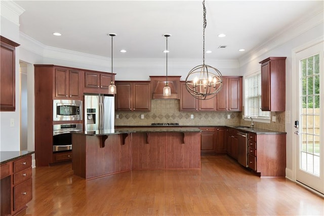4652 Prater Way SE, Smyrna, GA 30080 - kitchen featuring stainless steel appliances, light wood-type flooring, a chandelier, a kitchen bar, and a kitchen island