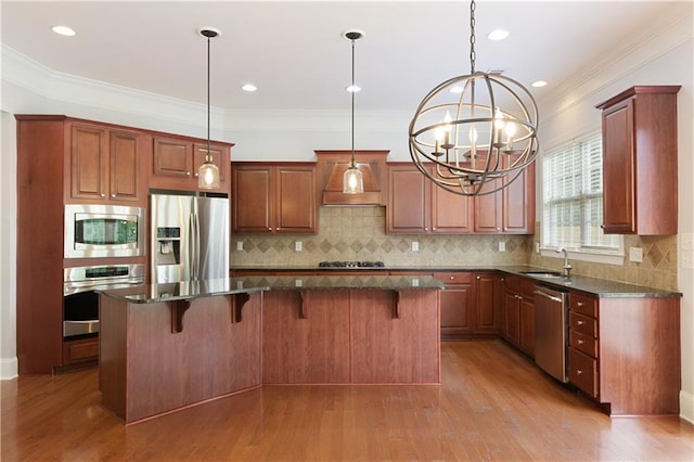 4652 Prater Way SE, Smyrna, GA 30080 - kitchen with stainless steel appliances, a chandelier, a kitchen island, a breakfast bar area, and ornamental molding