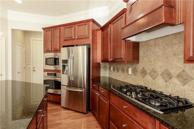 4652 Prater Way SE, Smyrna, GA 30080 - kitchen with stainless steel appliances, custom exhaust hood, crown molding, and dark stone counters