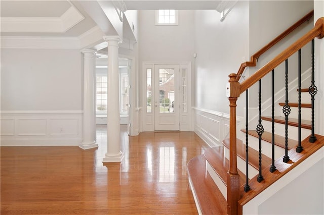 4652 Prater Way SE, Smyrna, GA 30080 - foyer entrance with a decorative wall, wood finished floors, decorative columns, stairway, and a wainscoted wall