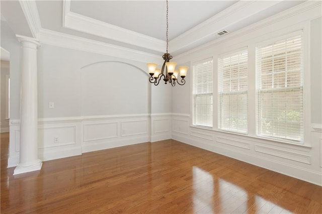 4652 Prater Way SE, Smyrna, GA 30080 - unfurnished room with decorative columns, a chandelier, wood finished floors, a wainscoted wall, and ornamental molding