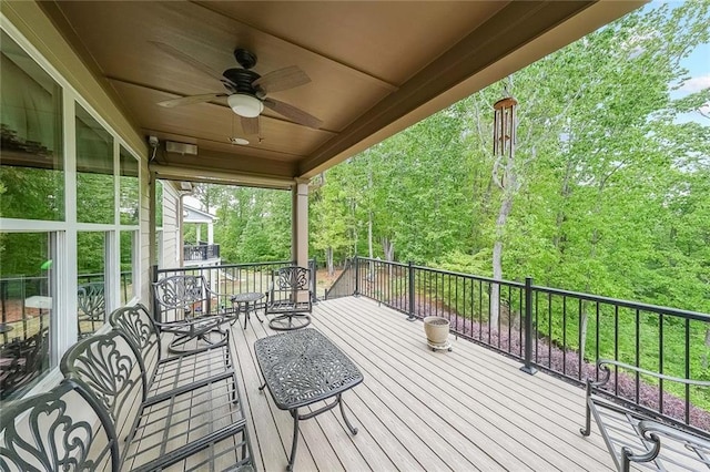 wooden deck with a ceiling fan