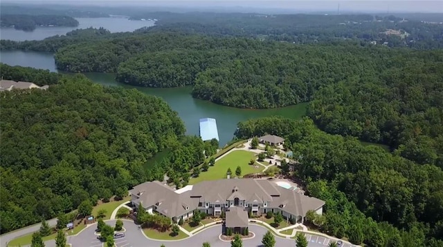 birds eye view of property with a water view and a wooded view