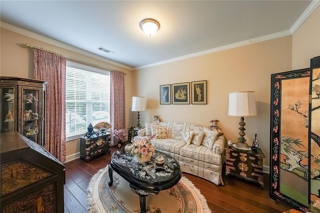 living room featuring crown molding, baseboards, visible vents, and hardwood / wood-style flooring