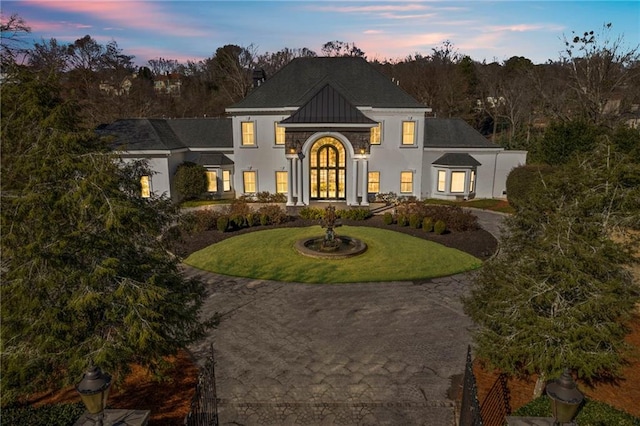 view of front of house featuring french doors and a yard