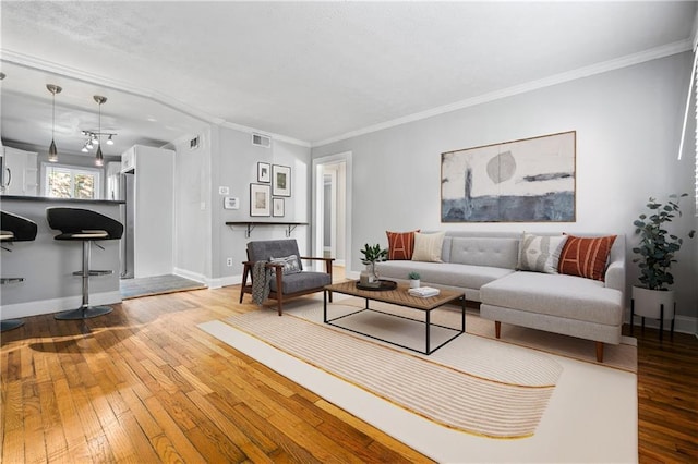 living room featuring hardwood / wood-style floors and crown molding