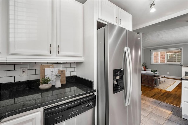 kitchen with decorative backsplash, light hardwood / wood-style flooring, white cabinets, and stainless steel appliances