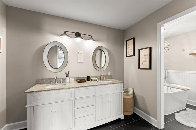 1536 Enota Ave, Gainesville, GA 30501 - bathroom with double vanity, tile patterned floors, visible vents, and a sink
