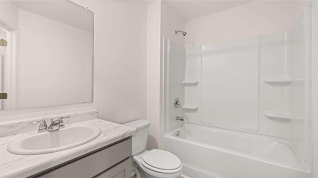 full bathroom with vanity, toilet, and  shower combination