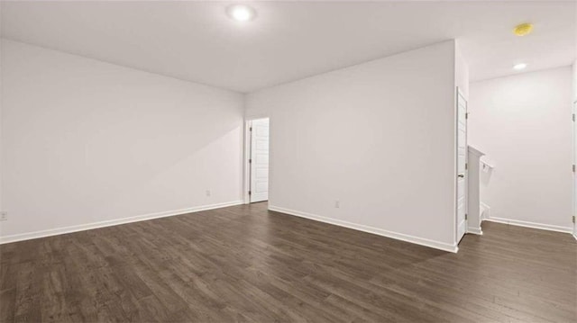 spare room with dark hardwood / wood-style floors