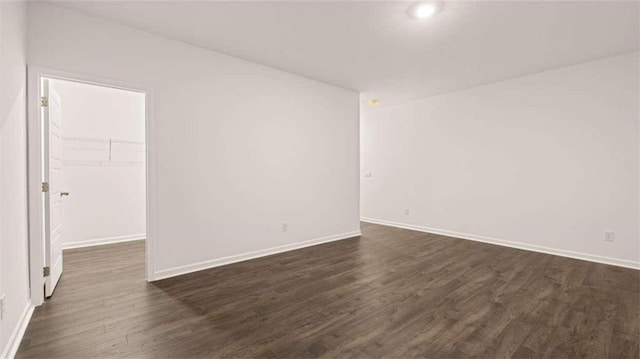 unfurnished room featuring dark hardwood / wood-style flooring