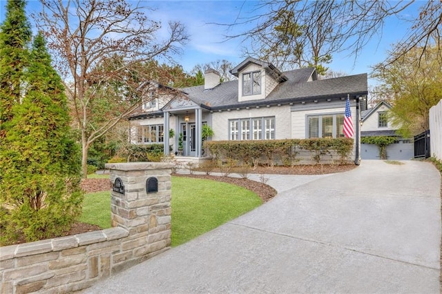 view of front of house featuring driveway and a chimney