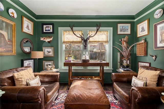 living area featuring ornamental molding and wood finished floors