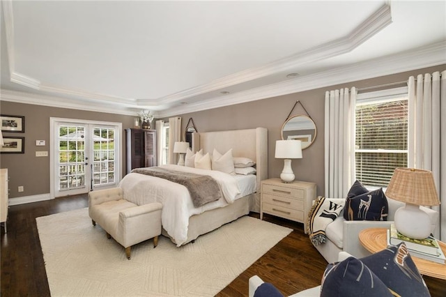 bedroom featuring french doors, a tray ceiling, dark wood finished floors, and access to outside