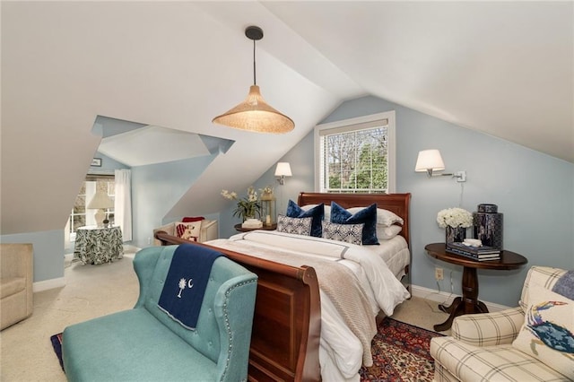 carpeted bedroom featuring lofted ceiling and baseboards