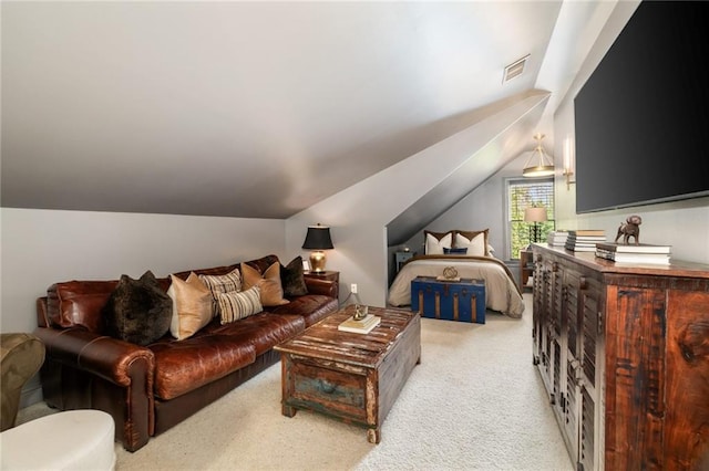 bedroom with carpet, visible vents, and vaulted ceiling