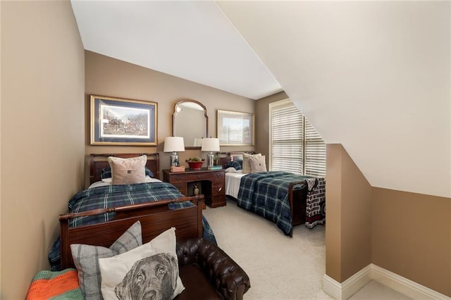 carpeted bedroom featuring baseboards and vaulted ceiling