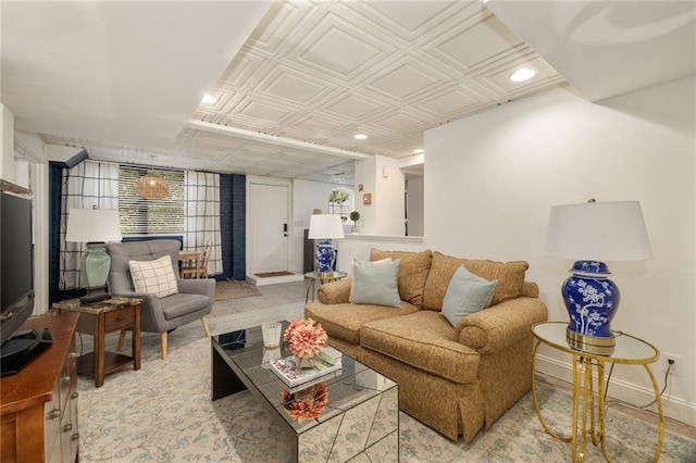 living room featuring recessed lighting, an ornate ceiling, and baseboards