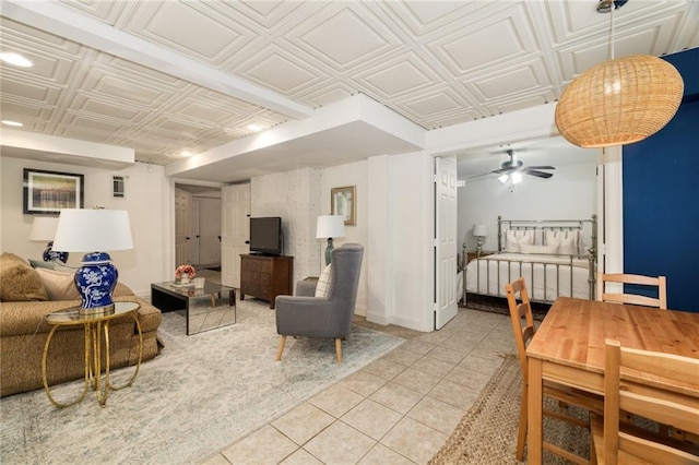 living area featuring light tile patterned floors, an ornate ceiling, and ceiling fan