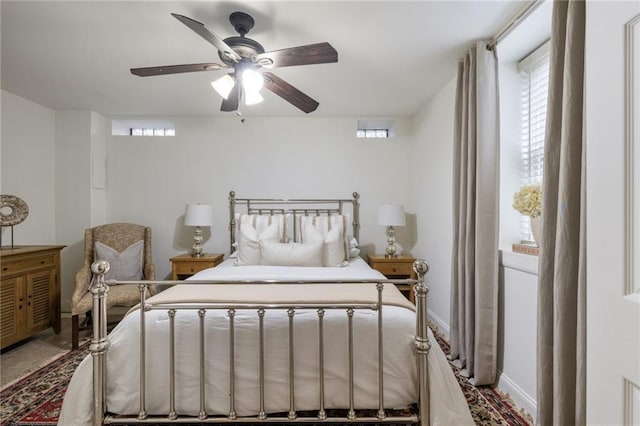 bedroom with a ceiling fan and baseboards