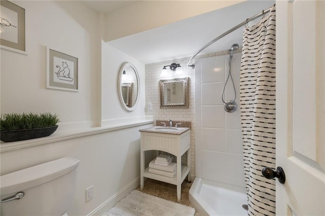 bathroom featuring vanity, a shower stall, and toilet